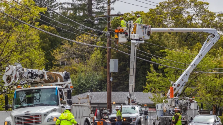 Utility crews and bucket trucks on a wet southeast Texas roadside after Tropical Depression Edouard